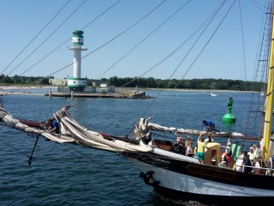 Leuchtturm Falckenstein, davor der Klüverbaum eines Segelschiffes.